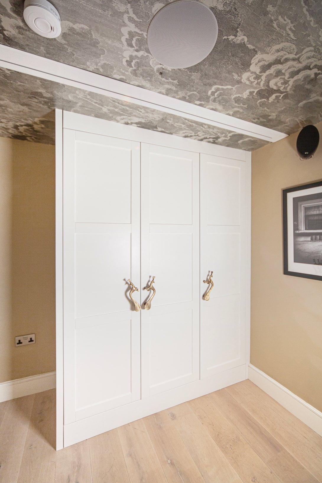 built in wardrobe with bespoke brass handles